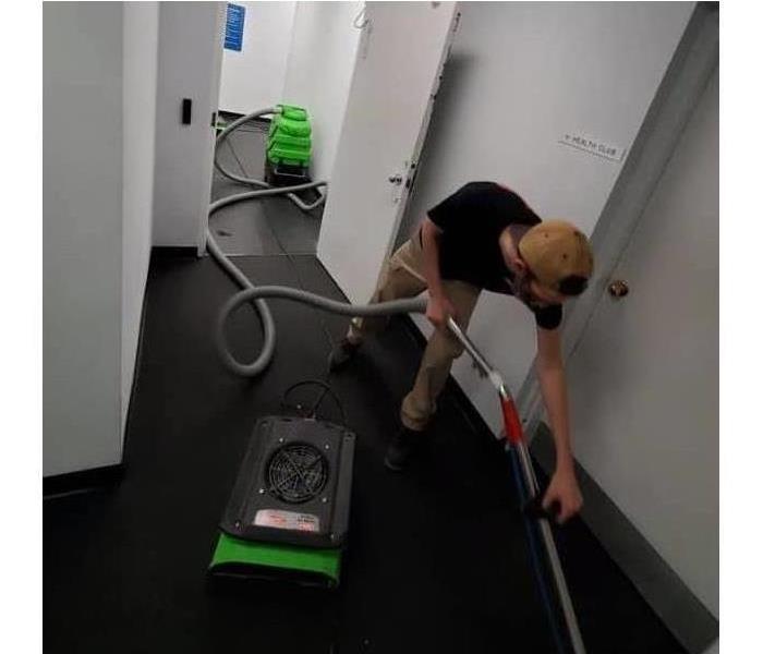SERVPRO employee cleaning water damage